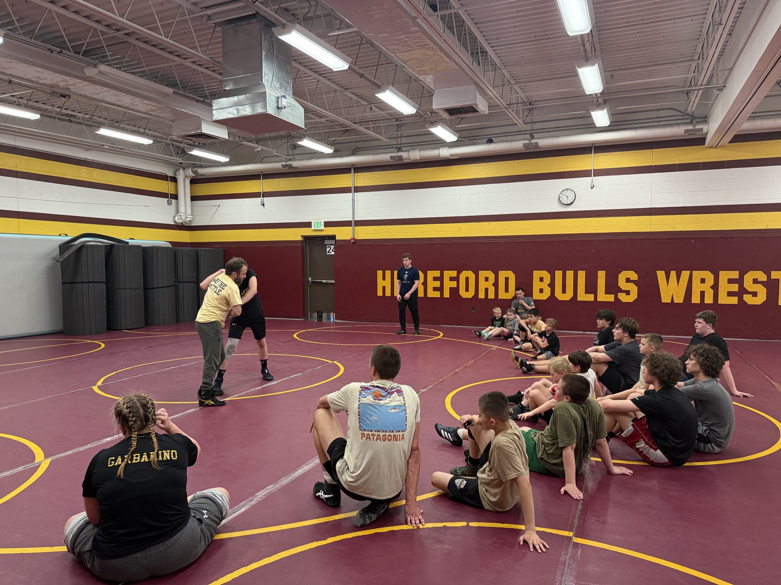 Coaches demonstrating technique during practice